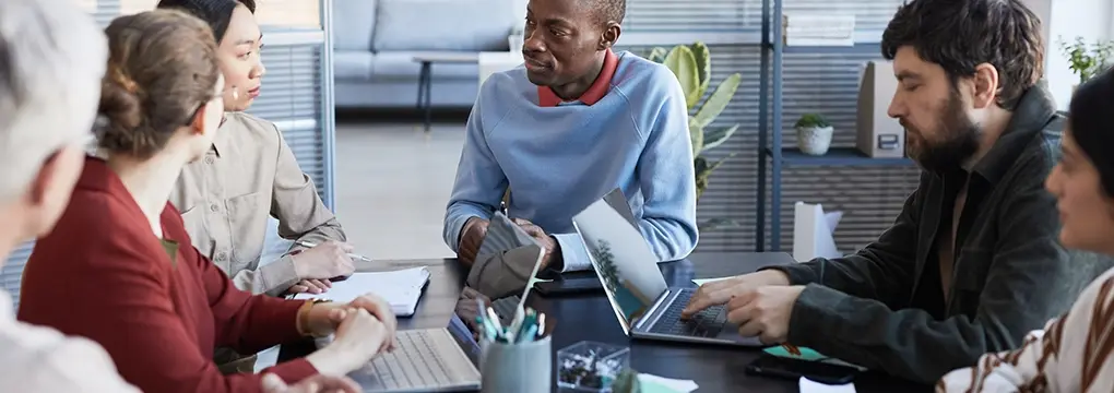 Diverse group of people sitting around a table working