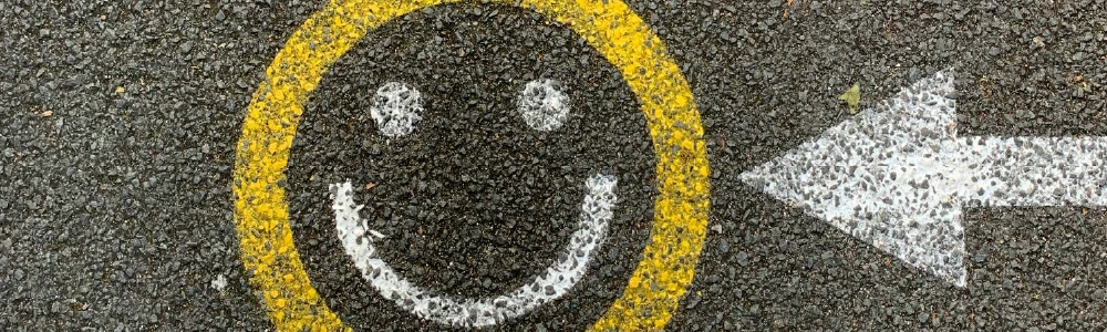 Smiley face painted on the pavement - it feels good to improve website accessibility.