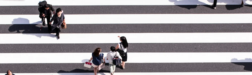 People walking across cross walk.