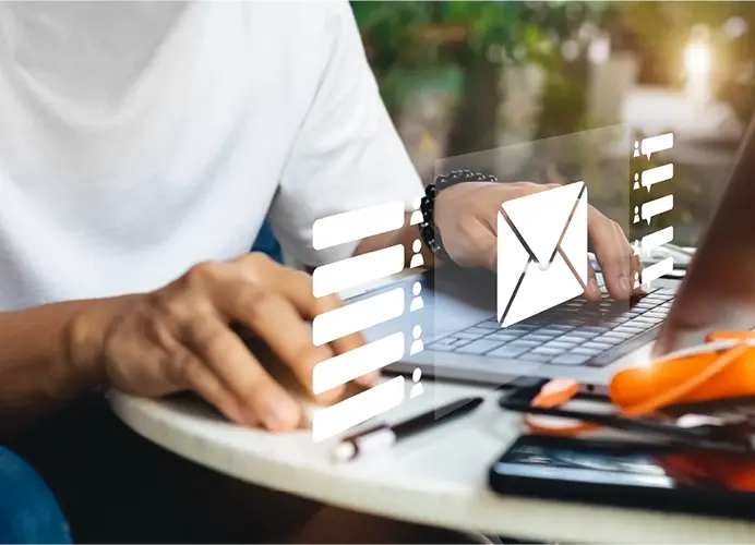 Man sitting at computer sending emails.